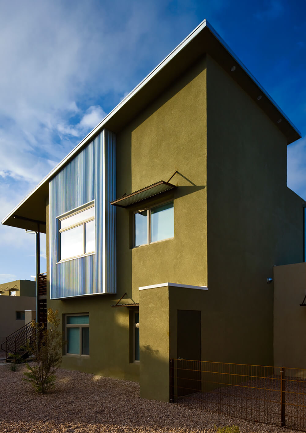 Olive stucco apartment home with a galvanized steel window bay at La Pradera, Hobbs NM